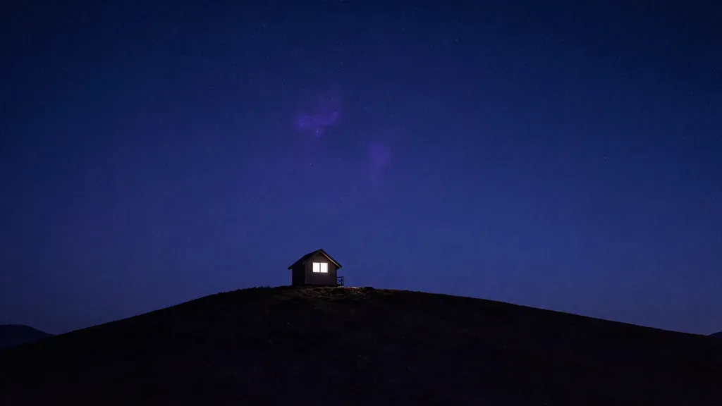 A lone house under a deep blue night sky